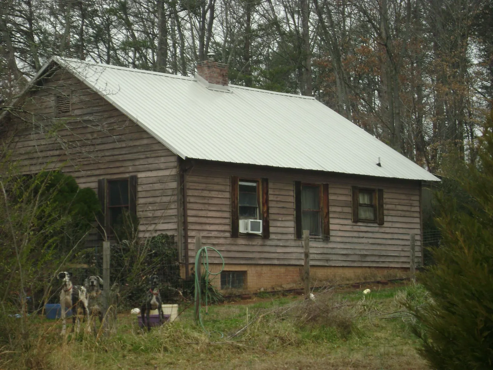 White metal roof on an old wood sided farmhouse, from a Metal Roof Installation job in Long Island